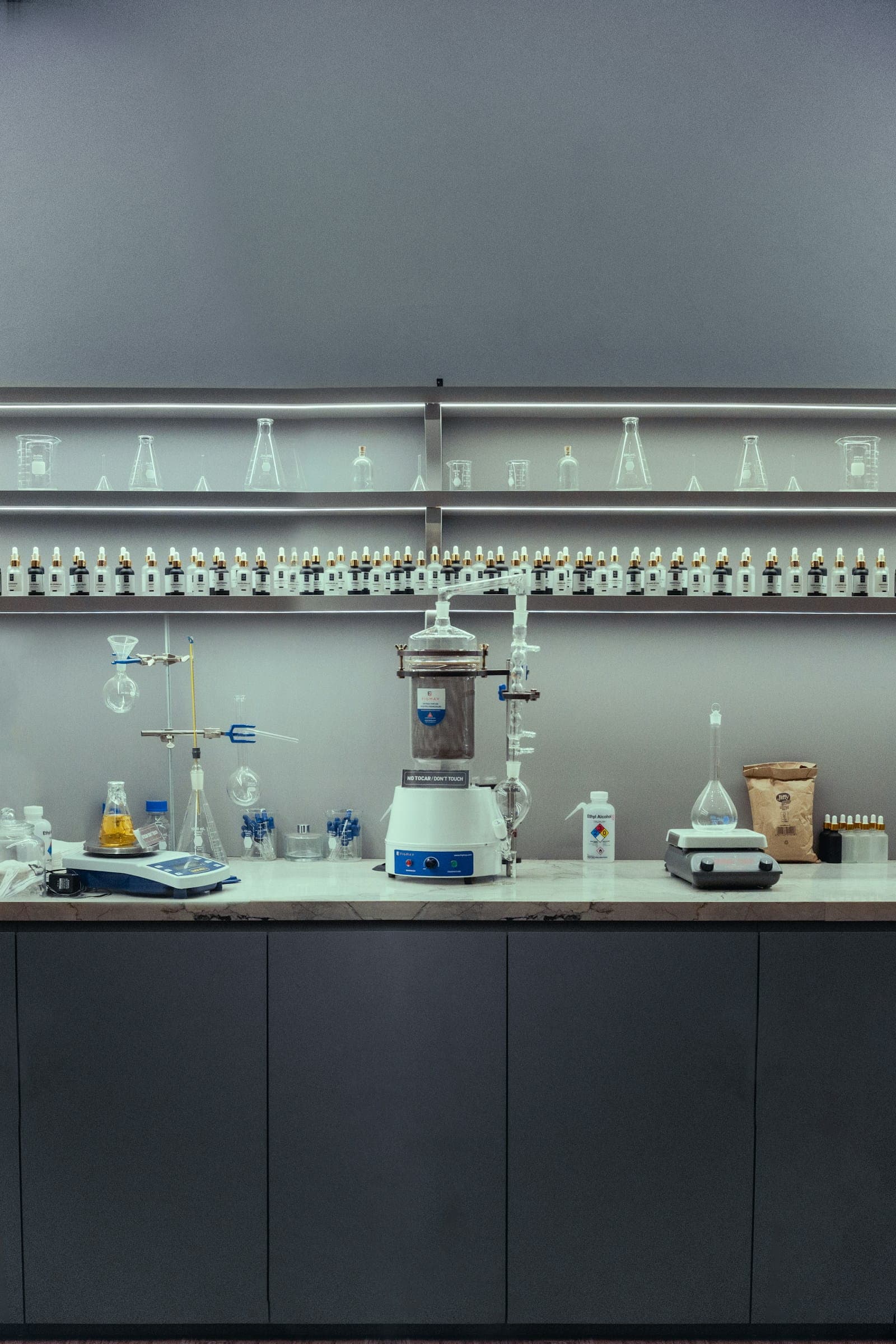 Analytical laboratory bench with glassware and testing equipment used for pharmaceutical quality control